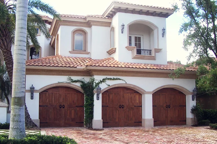 Florida home with three wooden signature series garage doors