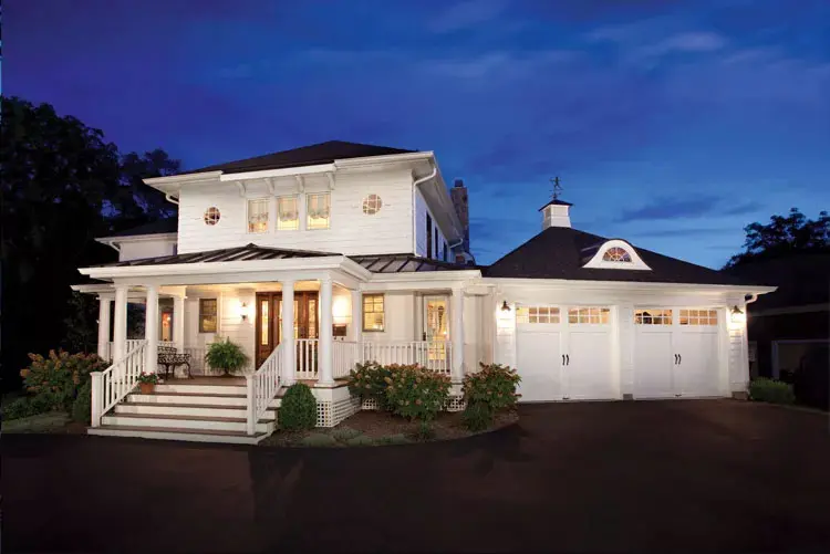 Home with two white, single-car Coachman Collection garage doors