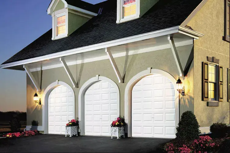 Home with three white premium series garage doors