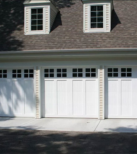 Three white Clopay garage doors with windows
